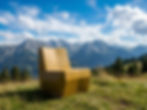 Outdoor lifestyle image with a small cabin in a mountain landscape.