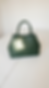 Green handbag shown in a simple phone product photo.