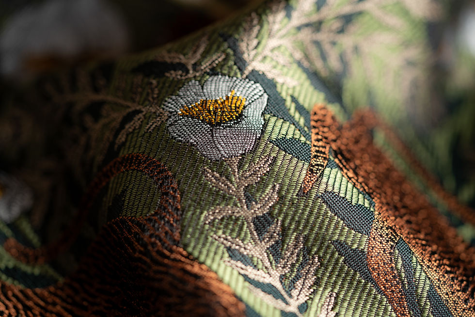 Tora Pistachio luxury woven textile, featuring expressive tigers among fern-like leaves and white blooms.