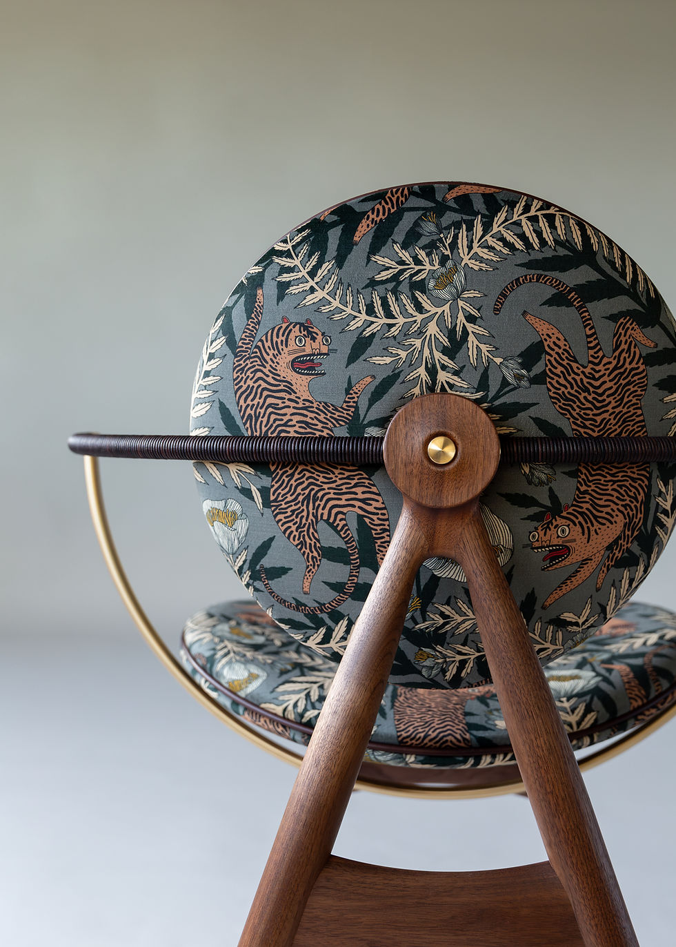 Thumbnail: oak dining chair upholstered in Tora Pistachio fabric with soft green tones and flowing tiger pattern