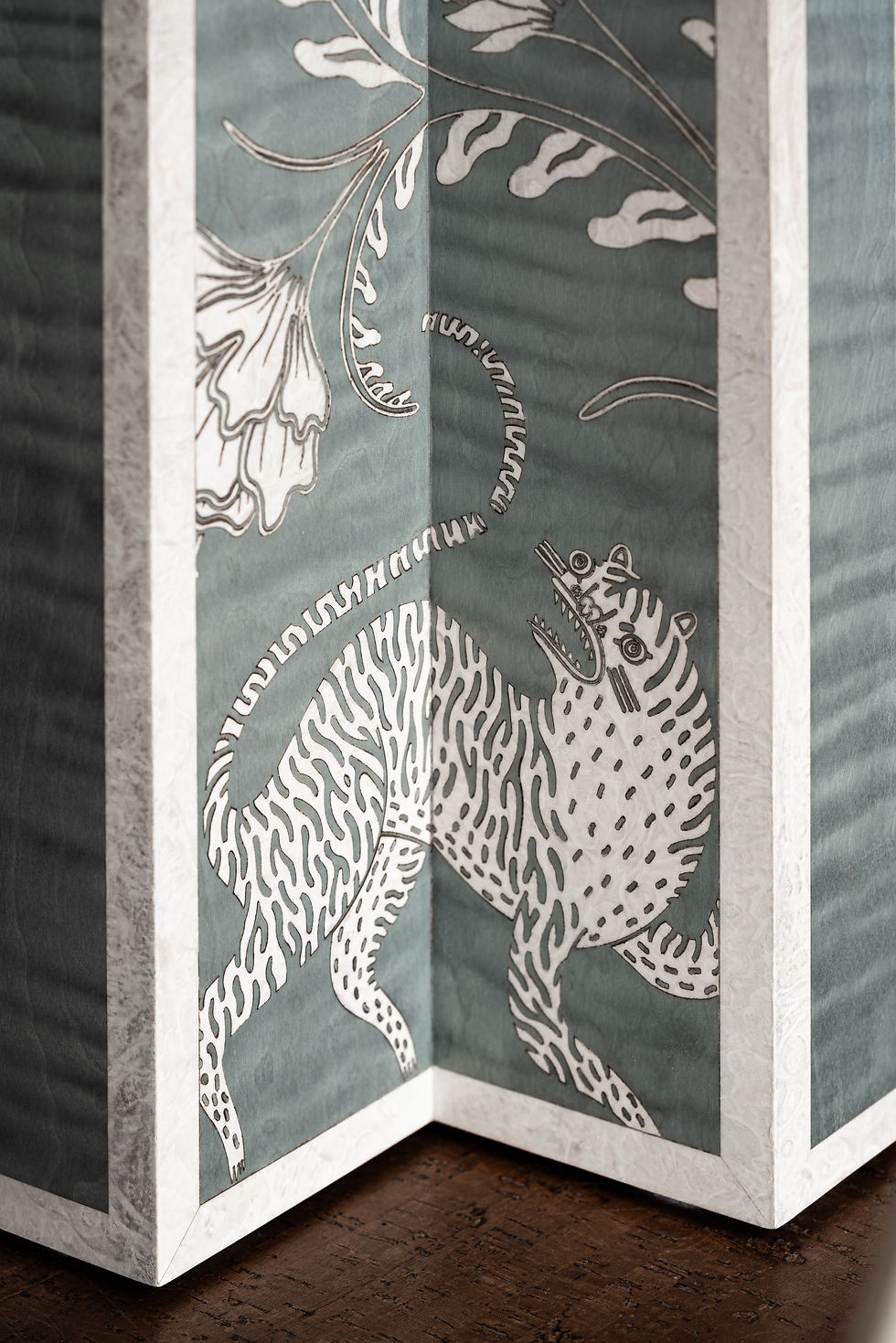 Thumbnail: Close-up of white tiger marquetry on the Panthera totem, inlaid in dyed veneer on a pale blue Figured Sycamore base