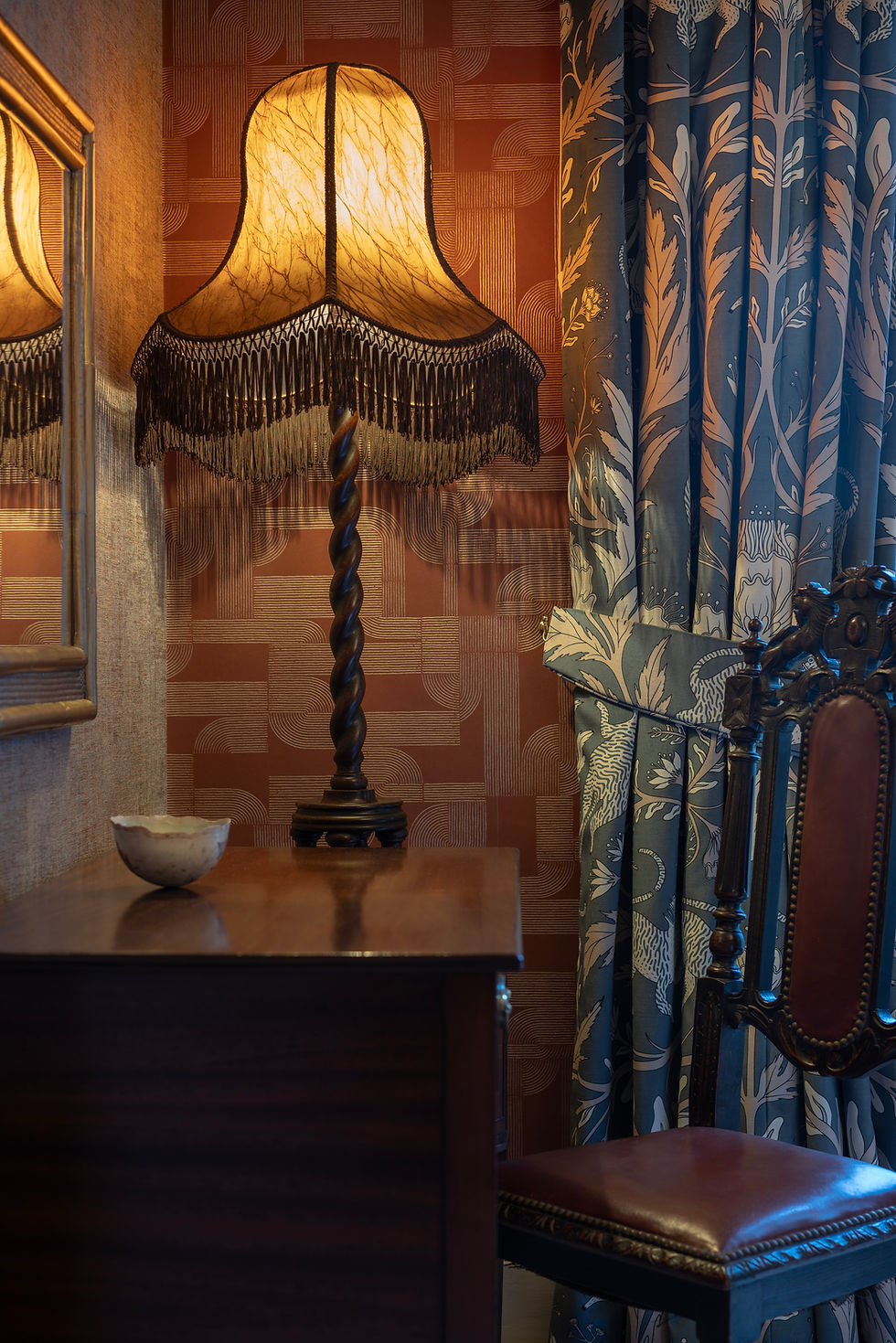 Thumbnail: Bespoke curtains in Panthera Savoy fabric with a coordinating tieback, set against rich red patterned wallpaper.