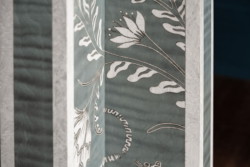 Thumbnail: Close-up of floral marquetry inlay on the Panthera totem, featuring dyed veneer of Figured Sycamore, Madrona Burl detailing