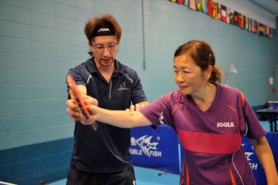 An OTTC member being corrected on her stroke by coach Steve