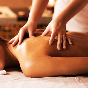 Hands massaging a woman's back