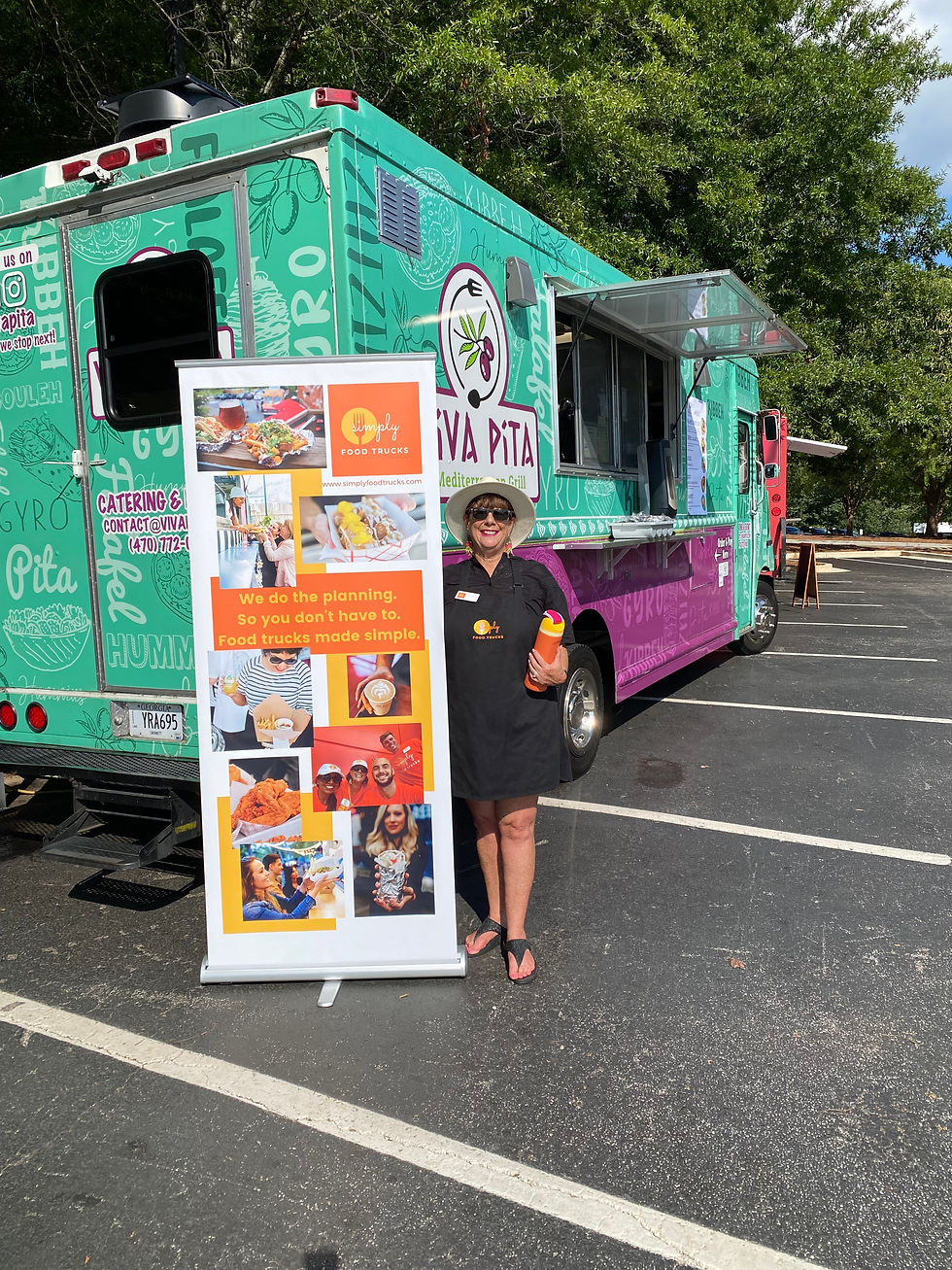 Paige Nathan standing in front of the Viva Pita food truck.