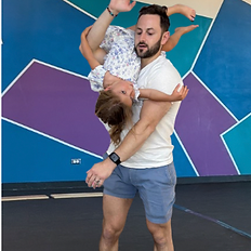 baby is learning acrobatics while adult gets a work out