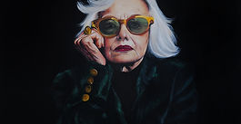 Portrait of older woman with white hair and sunglasses, looking self assured and bold