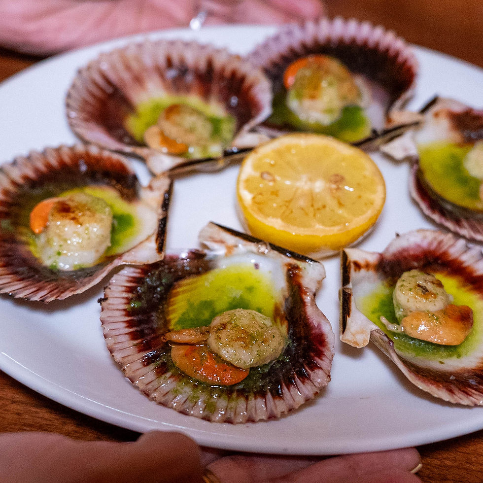 Fresh Galician-style scallops tapas with lemon at Tomiño Michelin restaurant NYC