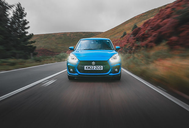 Suzuki Swift Sport Review - face on tracking image shot on the winding Snake Pass road in Derbyshire