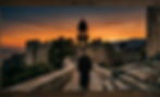 Monk in Silence – Mount Athos Journey (Orthodox monk walking along a stone path in Mount Athos monas