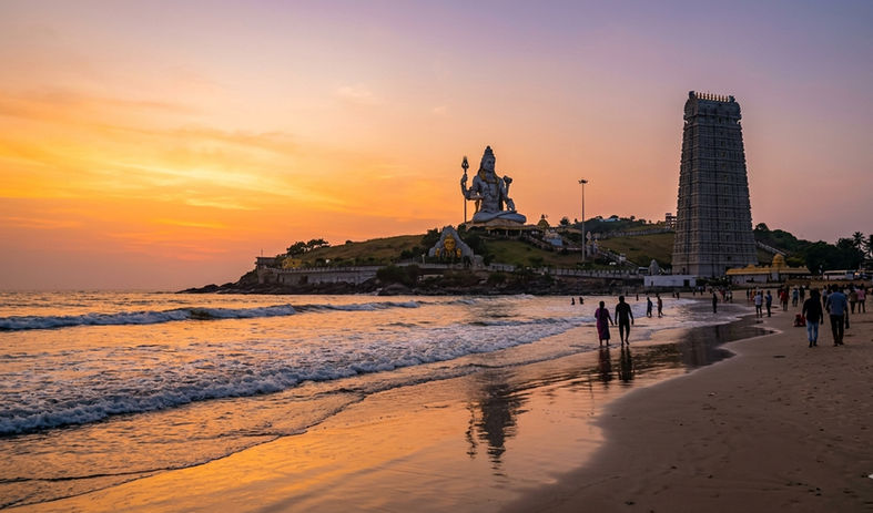 Murudeshwar beach with temple and Shiva statue at sunset