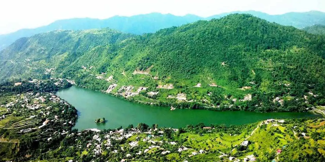 Christone Holidays showcases Bhimtal's serene beauty - The largest lake in Nainital district surrounded by emerald hills, featuring its iconic island temple at the center. Our Uttarakhand tour packages include peaceful boat rides on these crystal-clear waters, where visitors can admire the lush oak forests and Himalayan reflections. Perfect nature escape just 22km from Nainital, offering tranquil moments away from crowds.