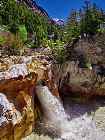 Waterfall of Ganges River flows across the Gangotri town tour with Christone holidays
