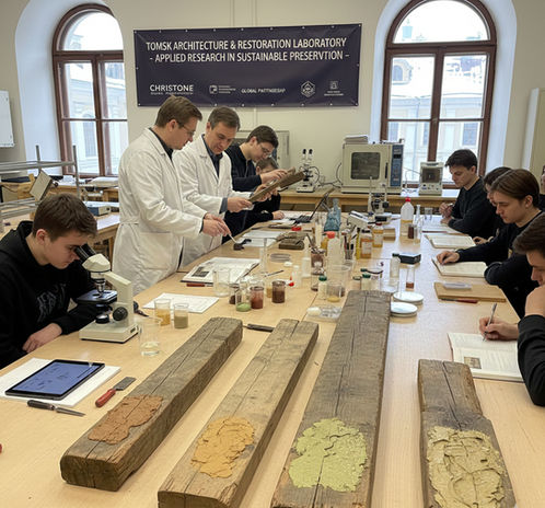Christone guests and university students testing sustainable restoration materials in Tomsk architecture laboratory