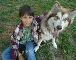 Smiling Boy Sitting with Dog