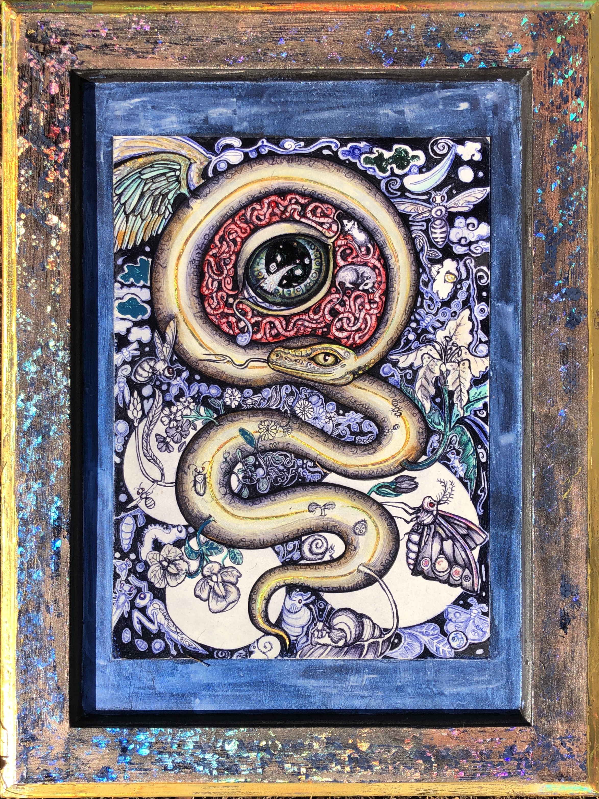 This painting was created with Ballpoint pen, watercolor and ink on paper, mounted to a repurposed kitchen cabinet door.  It depicts a golden snake slithering from bottom to top, circling back around itself to form a circle.  within the circle writhe red worms and rats.  Outside of the snake and the circle, Moths thrive and flowers bloom in indigo blue.  This piece represents how we can become trapped in the worries of our own minds, while the world and all of it's beauty blooms around us.  The snake symbolized rebirth, shedding those thoughts and finding amazing reasons to hang in there.