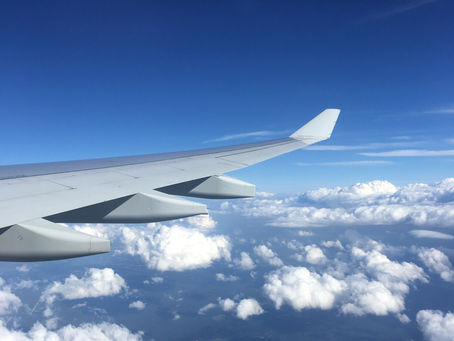A plane wing over clouds