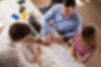 Top down view of couple meeting with financial advisor with laptop on desk