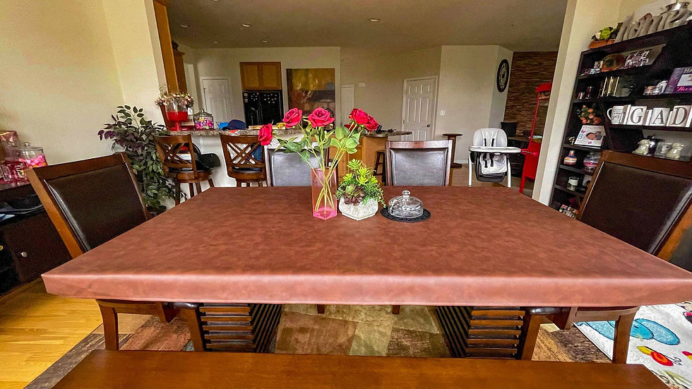 Vince Chestnut table cover on a brown wood table in a family kitchen with modern decor and natural light.