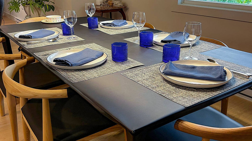Regan Obsidian table cover on a table with white and denim place settings in a blue and gray kitchen dining area.