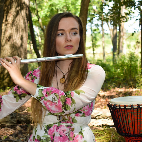Julia playing flute during a sound healing session outdoors.