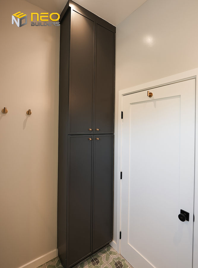 Floor-to-ceiling storage cabinet in a luxury above garage ADU providing concealed storage without taking up valuable floor space
