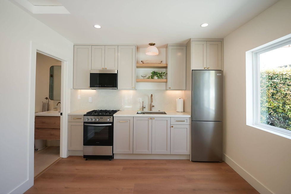 Bright ADU kitchen with large window, recessed lighting, and under-cabinet task lighting