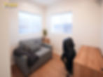 Office space inside a modern Inglewood ADU with desk, seating area, large windows, and flexible multi-purpose layout.