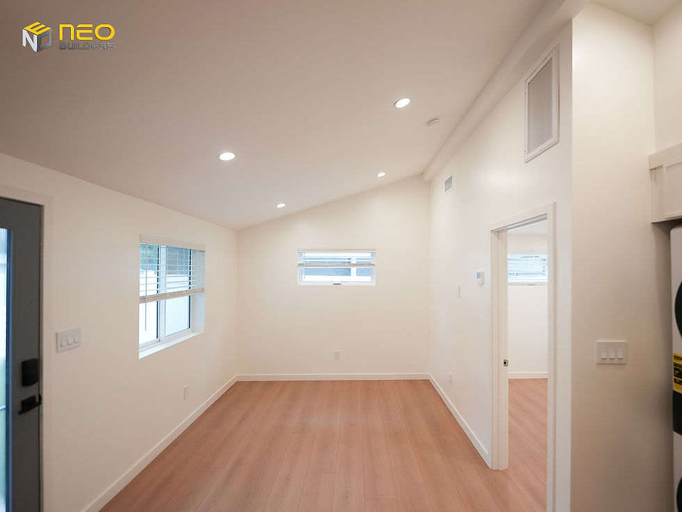 Open-concept living area inside a newly constructed two-bedroom ADU featuring high ceilings, large windows, and an efficient floor plan designed for long-term renters.