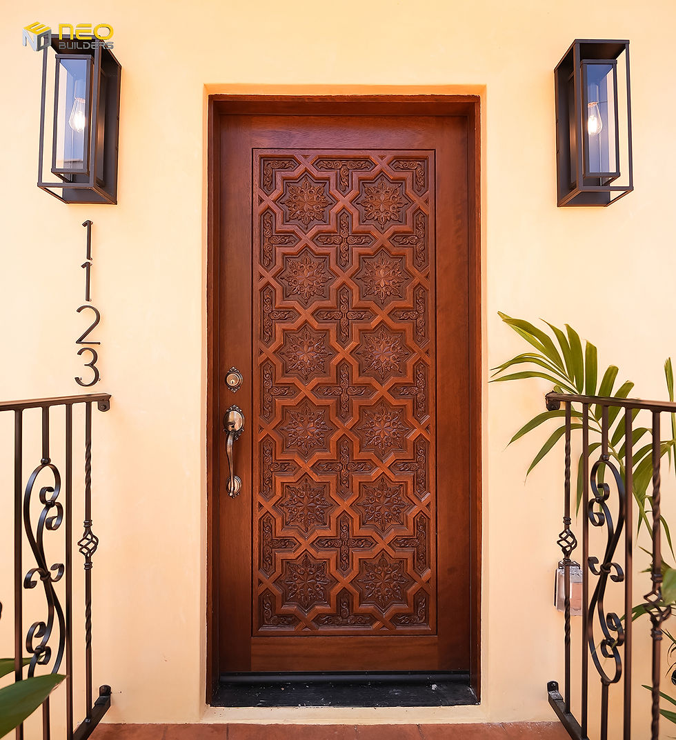 Custom carved wood front door on a newly built ADU in a Los Angeles HPOZ, designed with Spanish Revival details to match the historic duplex.