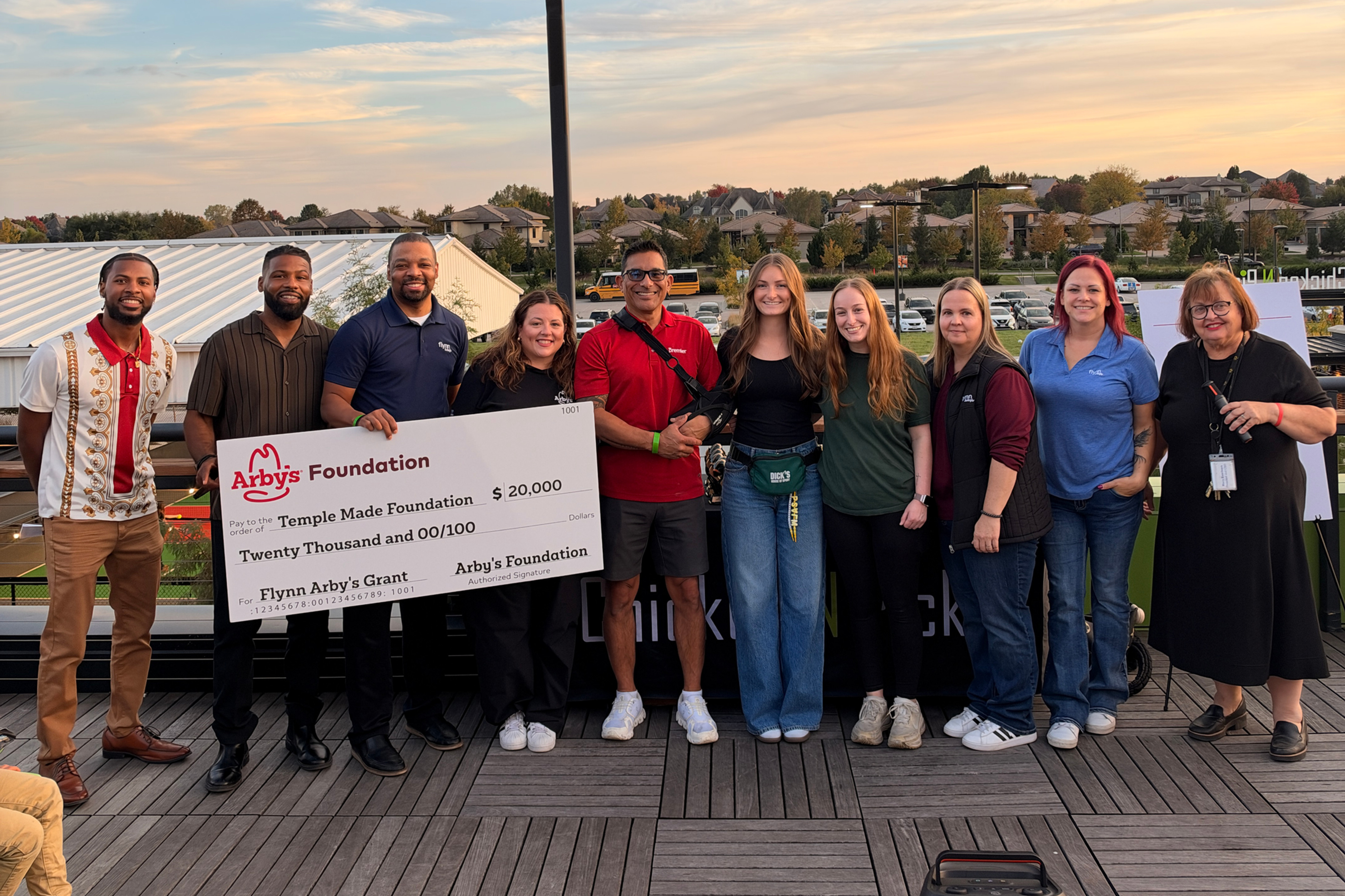 Arby’s Foundation and Flynn Group representatives present a $20,000 check to Temple Made Foundation with community supporters.