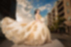 Quinceañera photoshoot at 16th Street Mall and Millennium Bridge in downtown Denver featuring a gold and champagne ball gown during sunset.