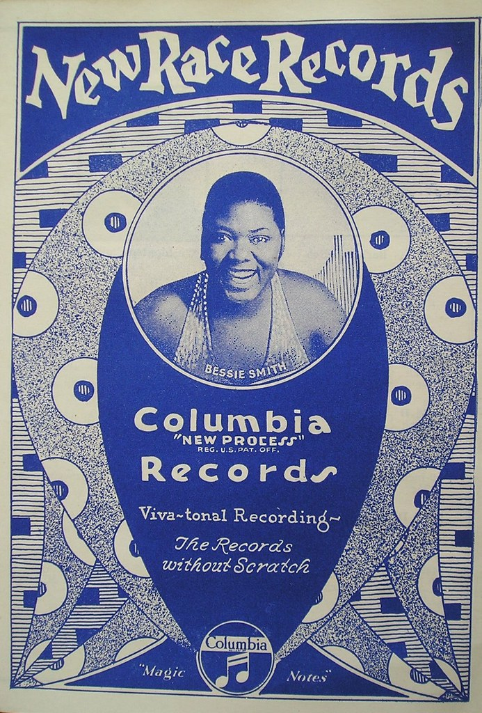 Vintage Columbia Records ad in blue featuring a smiling woman in a circular frame. Text includes "New Race Records" and "Records without Scratch."