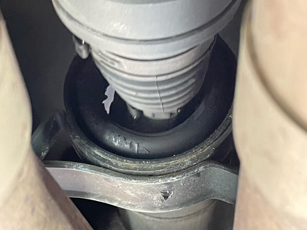 Thumbnail: worn factory driveshaft center support carrier bushing showing cracking and deterioration