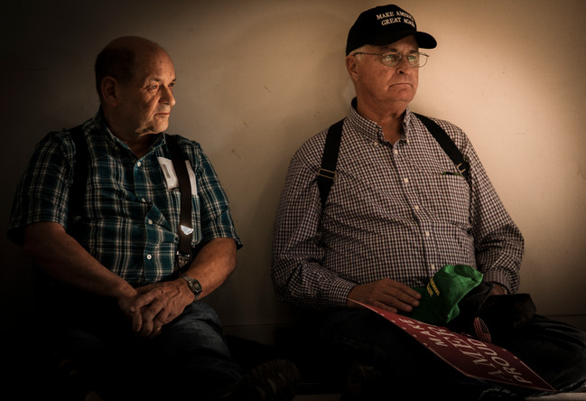 Randy Lamphere, left, sits with a friend, who prefers to go unnamed, in a sunbeam slanting into the hangar at about 4:30 p.m.