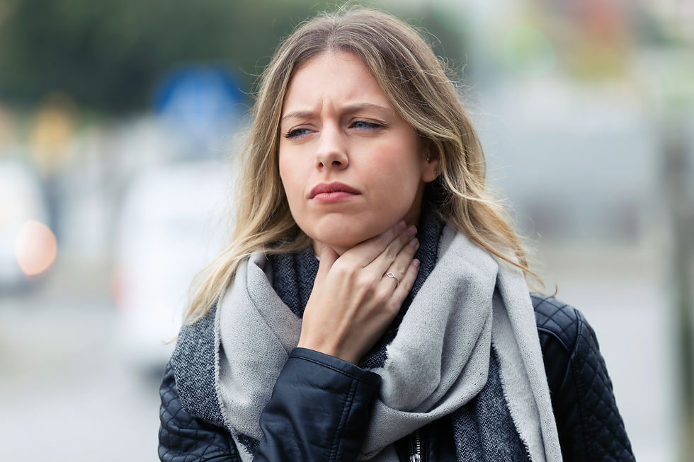 A woman holds her sore throat before taking oregano oil for her sore throat