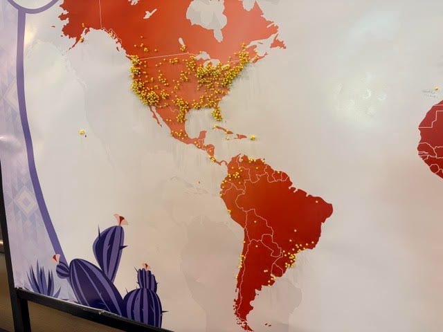 Pins on a map showing home countries. .. . .