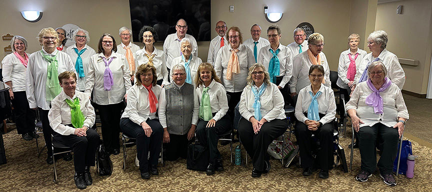 During the Christmas shows, the St. Cloud Area Fun Singers dress in matching red vests. But in the warm months, the group switches to colorful scarves and ties. 
