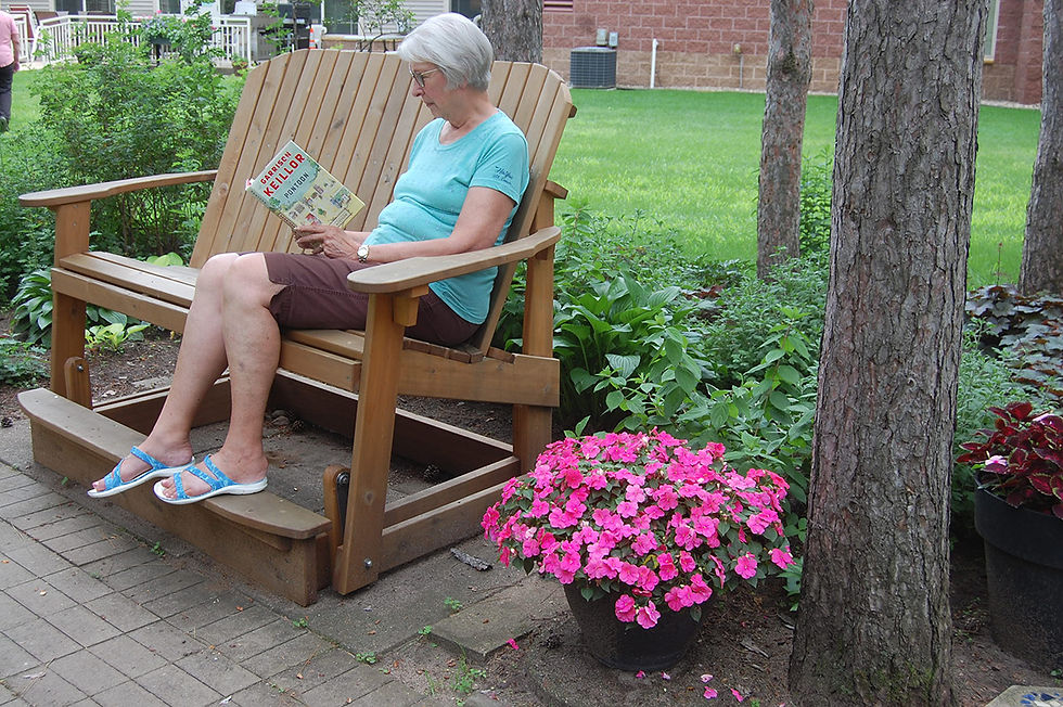 Gloria Meidinger relaxes with a book in the garden area at Realife Cooperative. Photo by Scott Thoma