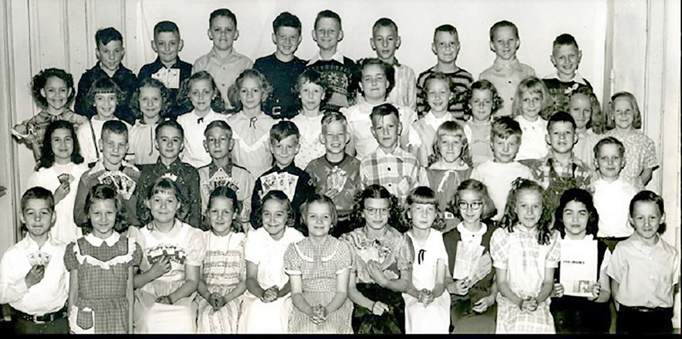 The 1951-1952 third- and fourth-grade students of Our Lady of Lourdes School in Little Falls took part in a bigger-than-life-size artwork of the Madonna and Infant Jesus. The students in Sr. Elvan’s class who participated in making the button Madonna include (Front L to R): Gerald Tuholski, Karen Copa, Gladys Socher, Jeanette Ringwelski, Mary Gamradt, Marilyn Henn, Patricia Piekarski, Diane Stay, Audrey Hines, Karen Anderson, Carolyn Dybdall, Albert Heurung; 2nd row L to R: Darlene Adams, Lawrence Johnson, Robert Pelkey, Jerome Podraza, Gerald Ginter, John Kulus, John Tabatt, Eva Zeck, Robert Adelmeyer, Robert Kalinowski, Otto Wilczek; 3rd row L to R: Sharon Dengel, Carol Ann Kalis, Margaret Pietrowski, Doris Wielinski, Elizabeth Lutz, Maryann Zaren, Diane Wojciechowski, Diane Stroschein, Roselyn Wielinski, Marlene Hennek, Henrietta Fischer, Janet Ringwelski; Back row L to R: Dale Eisel, Michael Schlax, Thomas Wielinski, Richard Chirhart, Constantine Zak, Donald Karnowski, Michael Johnson, Lawrence Miller, Ronald Zak.