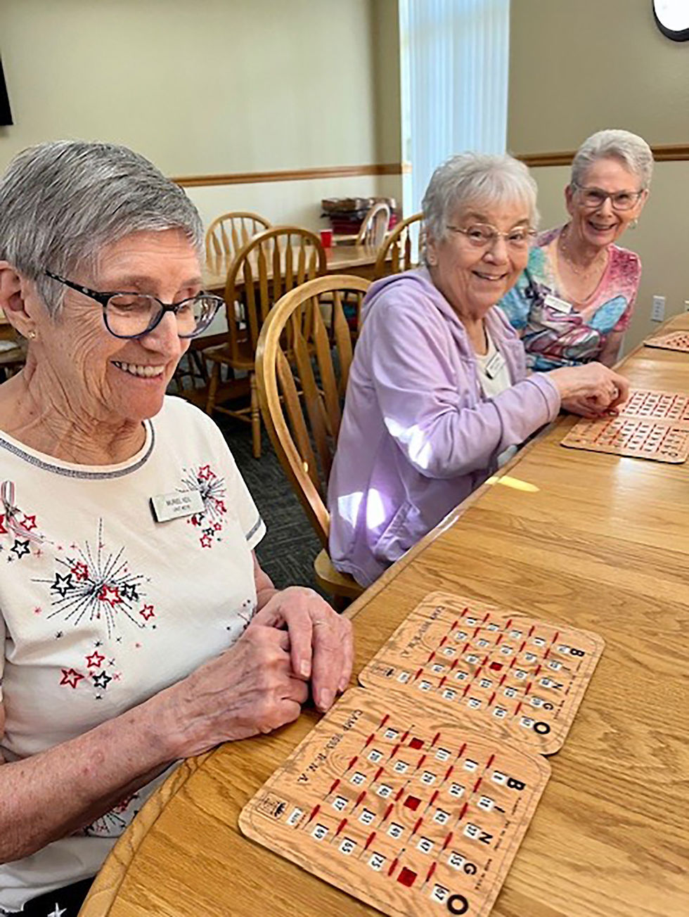 Muriel Keil, Mary Jo Herr and JoAnn Malikowski (left to right) play Bingo at a Fourth of July celebration.