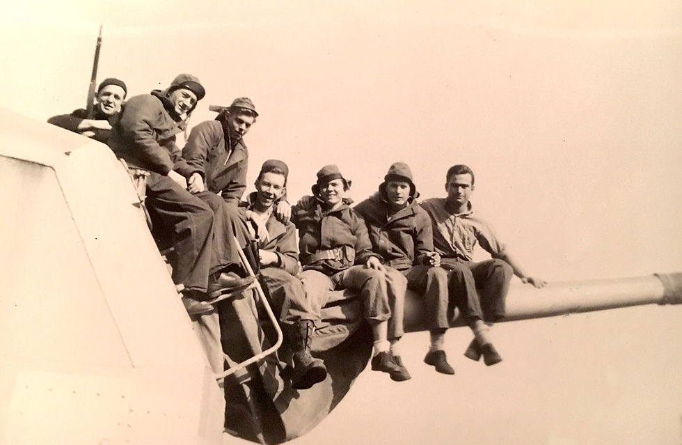 Jim Clermont (third from right) and his comrades sitting on a gun on the USS Herndon II (DD 638). Photo contributed.