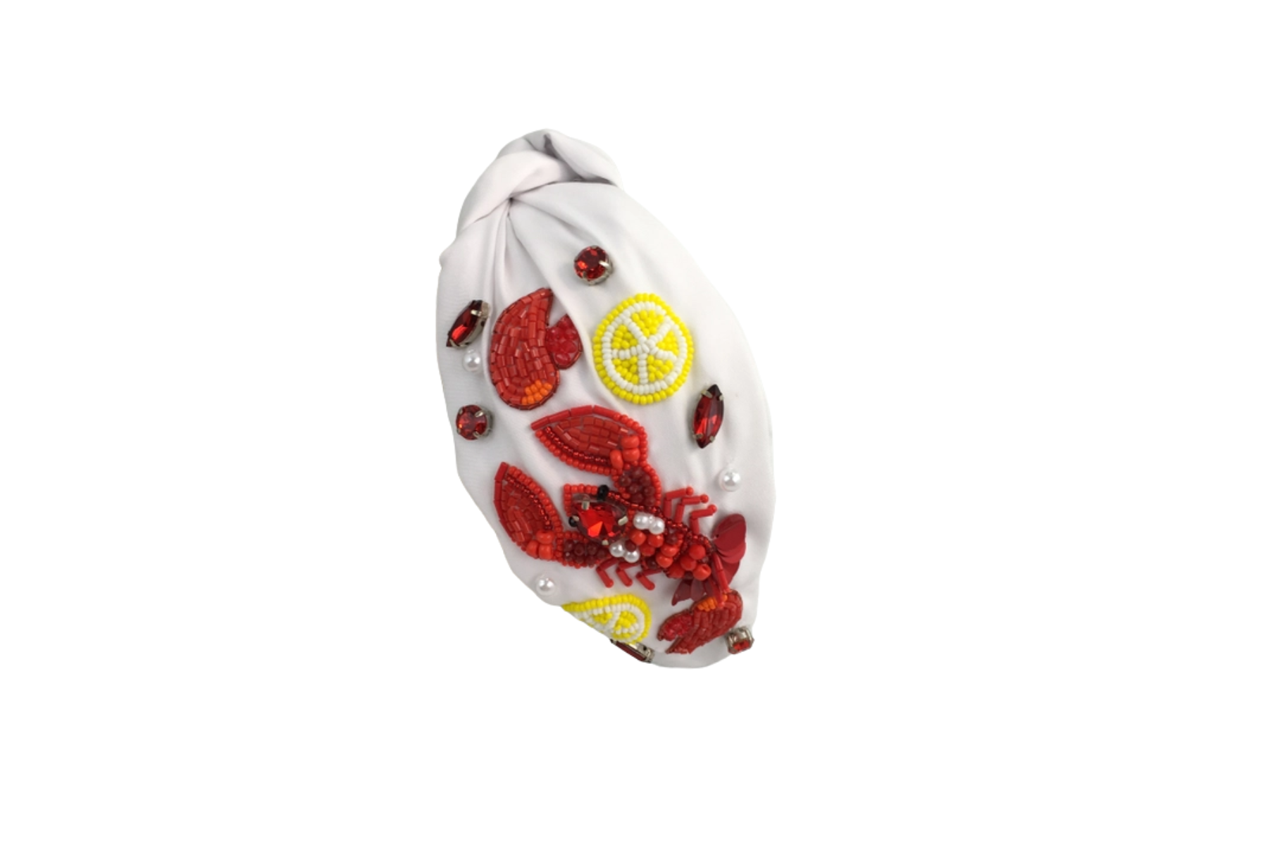 White headband with crawfish, lemon, and red gem details isolated on white.