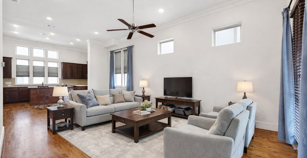 Open-concept living and dining area with hardwood floors and natural light at 705 Delano Street, Houston, TX 77003