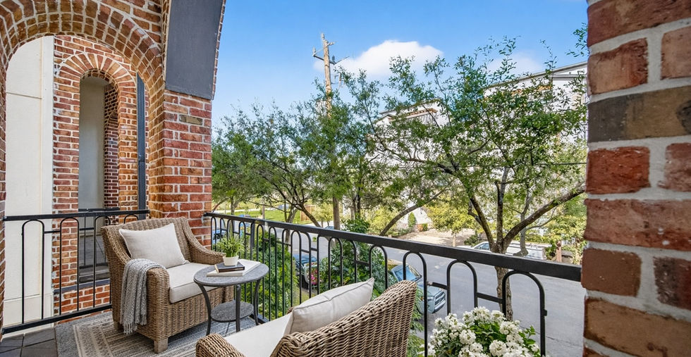 Second-floor covered balcony with wrought iron railing and outdoor seating at 705 Delano Street, Houston, TX 77003