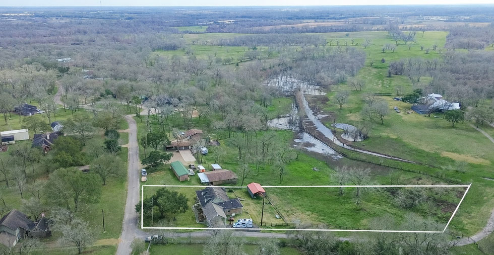 Aerial view with property boundary showing home, outbuilding, and acreage at 35531 Pontiac Drive, Brookshire, TX 77423