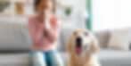 A woman sneezing from pet allergies