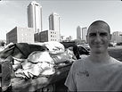John Schott in front of Indianapolis skyline providing junk removal.