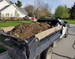 A fully loaded dump truck of dirt being hauled away by Schott Services.